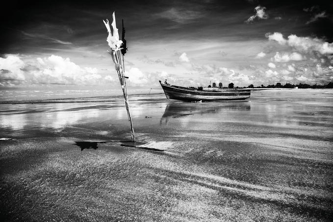 Black and white image of a boat on a river